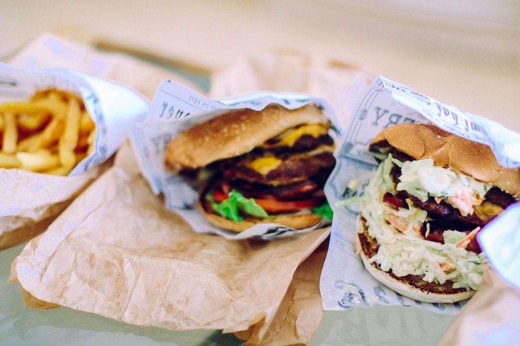 Two burgers with potato fries