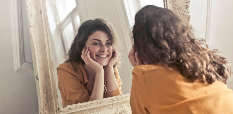 Woman facing a mirror