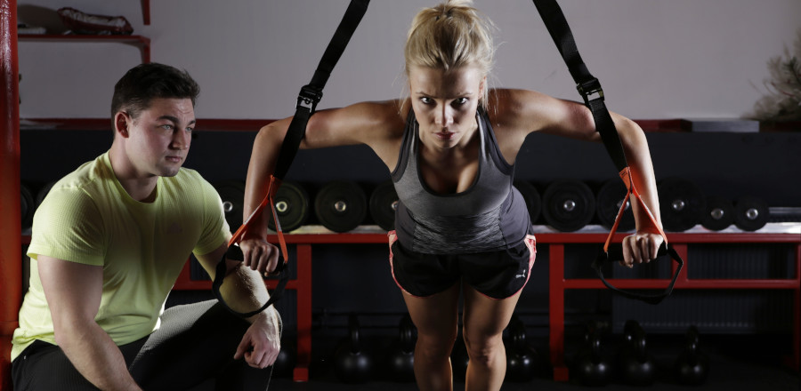 Woman working out with a trainer