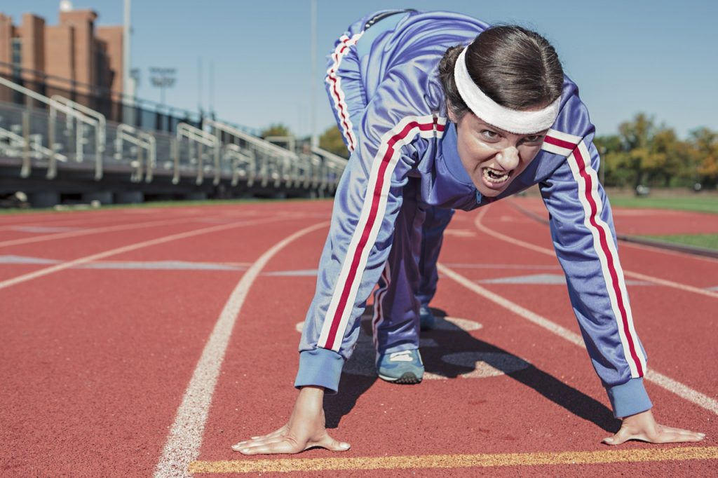 A woman starting off on the track field