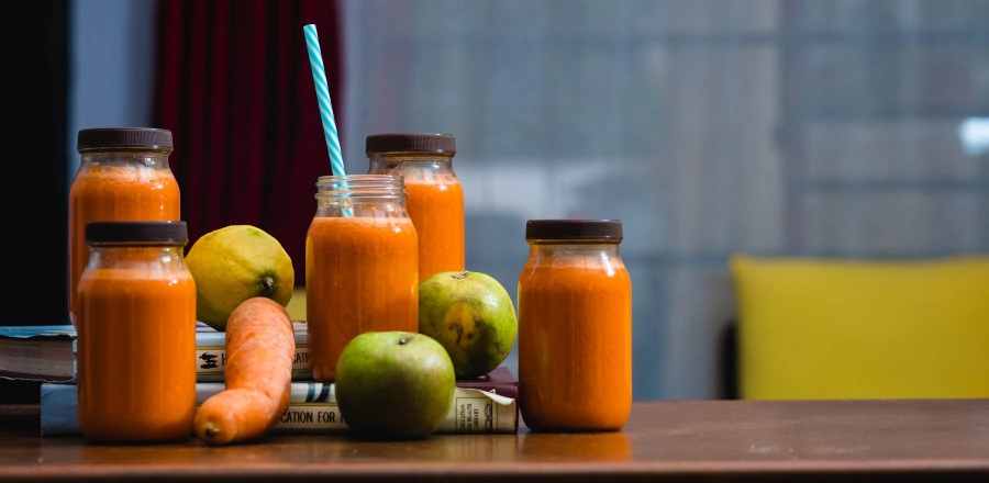Carrot juice in jars