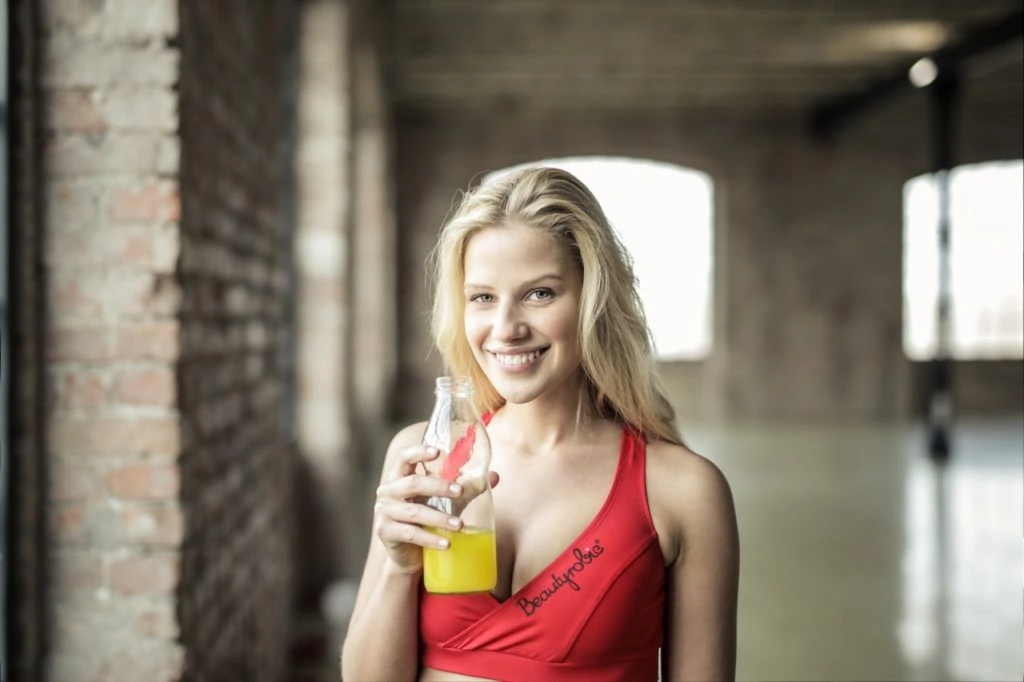 A woman drinking her health drink in the gym