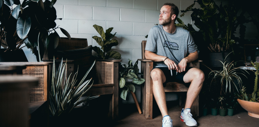 Man sitting surrounded by plants