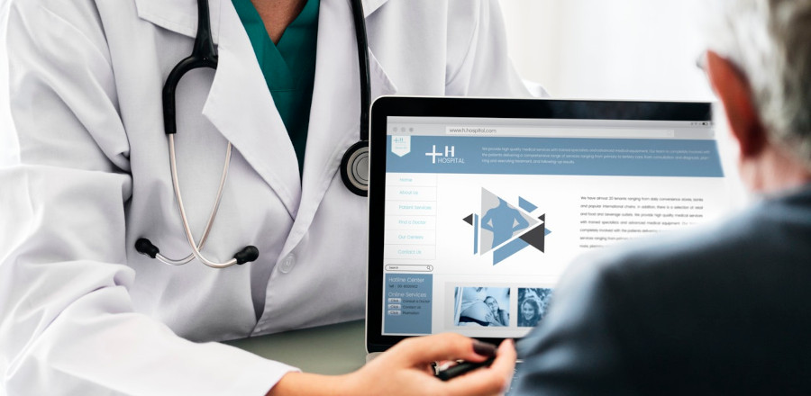 Doctor with a laptop talking to a patient