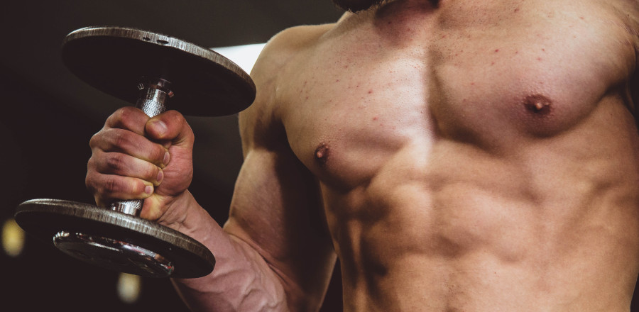 Muscular man holding a dumbbell