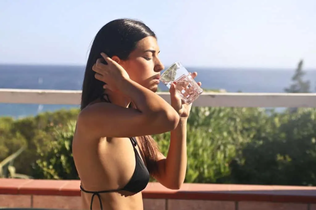 Sexy woman drinking water