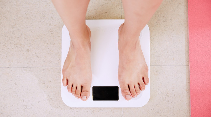 A person on top of a weighing scale