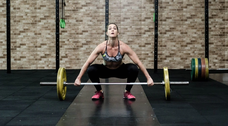 Woman lifting bars in a gym