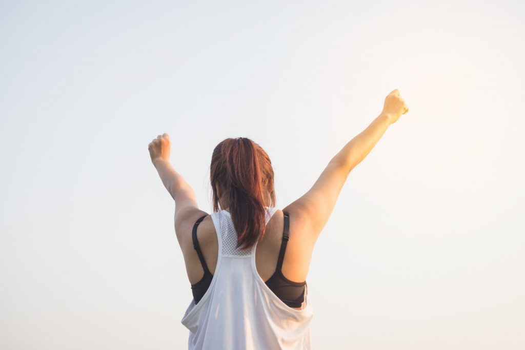 Woman raising arms