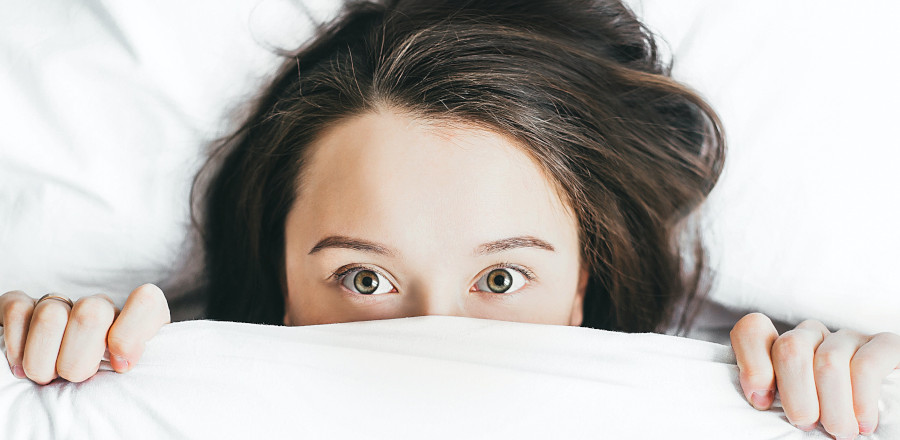 Woman wide awake at bed