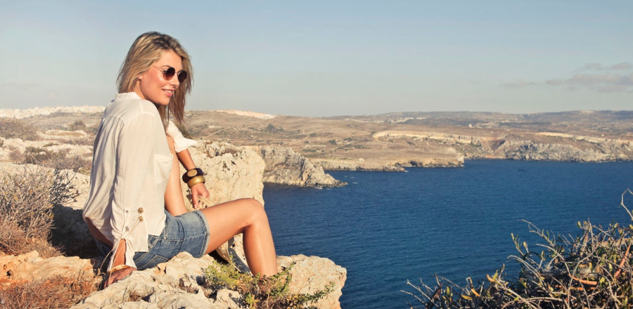 A woman enjoying the scene by the cliff