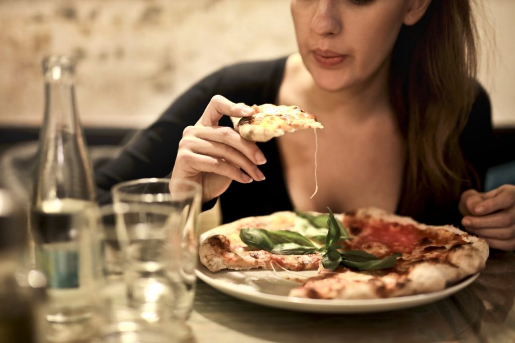 Woman eating pizza