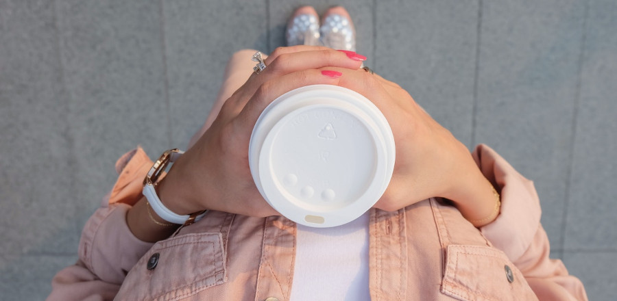 Woman holding one plastic cup