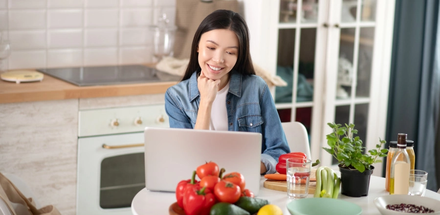 Woman using a laptop in the kitchen