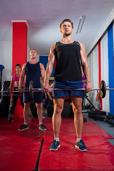 Athletes lifting barbells in the gym