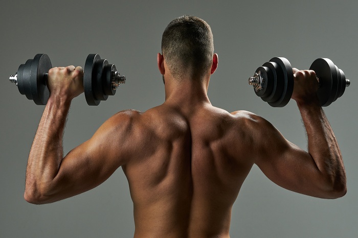 Bodybuilder working on his body muscles