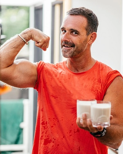 Middle aged man holding protein drinks
