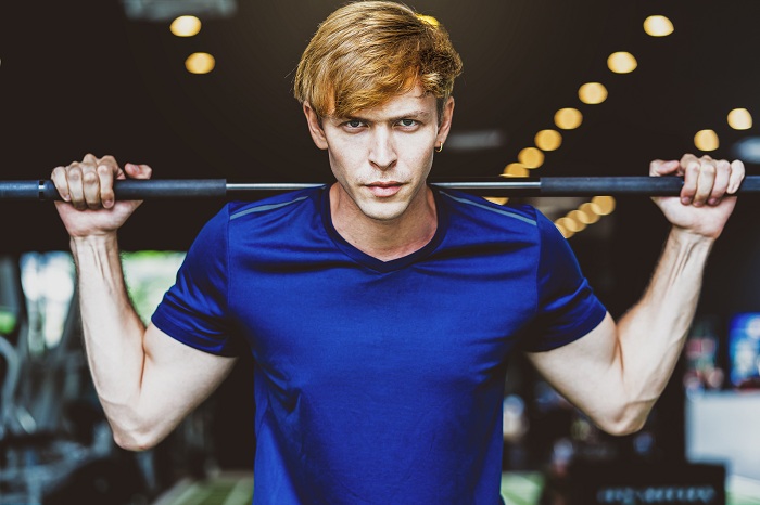 Young man doing morning lifting exercise