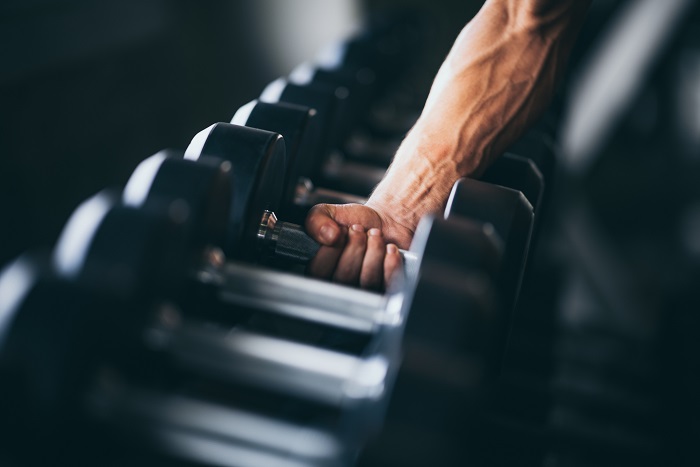 rows of dumbbells in a gym lining up before training