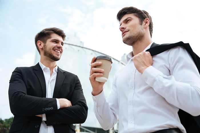 2 businessmen talking and drinking coffee